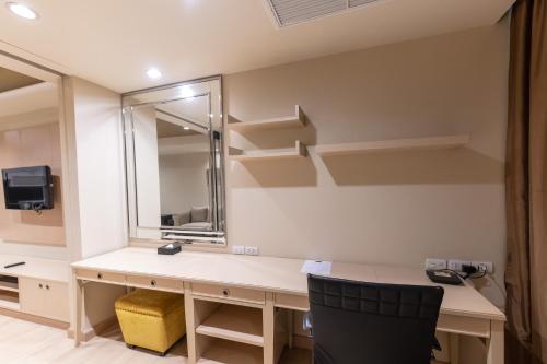 an office with a desk with a mirror and shelves at Admiral Premier Bangkok in Bangkok