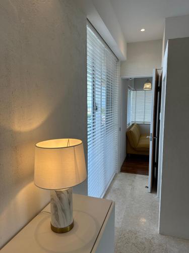 a lamp sitting on a table in a room at KATSUREN Blue. in Uruma