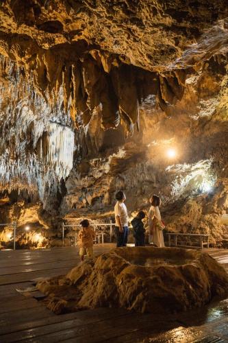 a group of people standing in a cave at KATSUREN Blue. in Uruma