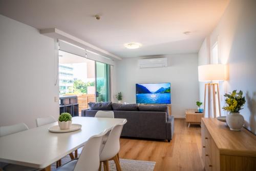 a living room with a table and a couch at 3-Bedroom Unit with River Views and Balcony in Brisbane