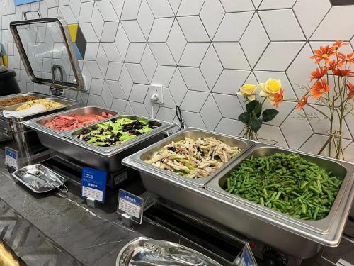 a buffet with three trays of different types of vegetables at Holiday Inn Express Nanchang Bayi Square by IHG in Nanchang
