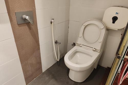 a bathroom with a toilet with the lid up at Hotel 18 Ipoh Aeon Mall in Ipoh