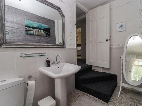 a white bathroom with a sink and a mirror at Rock Hollow in Halifax
