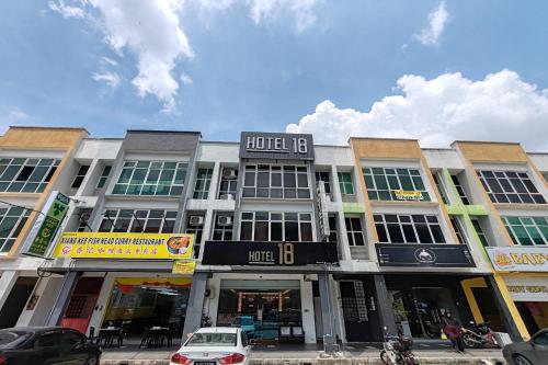a building on a street with cars parked in front at Hotel 18 Ipoh Aeon Mall in Ipoh