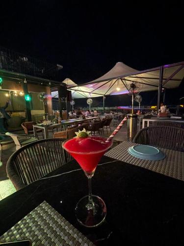 a drink in a martini glass sitting on a table at Hotel Three Seasons in Vrindāvan
