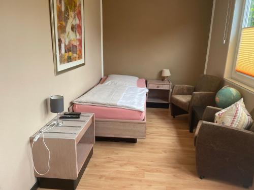 a small room with a bed and a couch at Hotel Am Sportpark in Duisburg