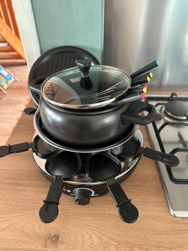 a pan sitting on top of a stove with utensils at Le coup de c’Heurt duplex 100m de la mer 8 personnes in Le Portel
