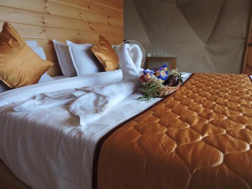 a swan made out of towels on a bed at L.T NATURE GLAMPS in Kodaikānāl