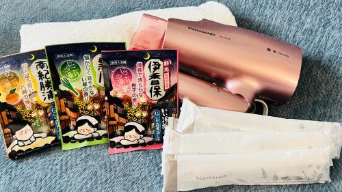 a pile of books sitting on the ground with a bag at Joyhome 天下茶屋駅徒歩7分広々4LDK一棟貸し 難波梅田空港直通 無料駐車 in Osaka