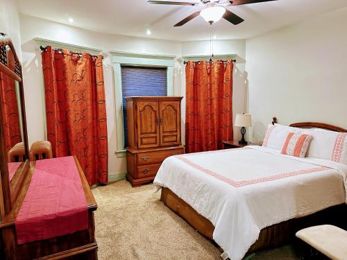 a bedroom with a bed and a dresser and a window at Elmwood village home in Buffalo