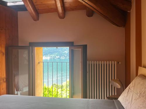 a bedroom with a window with a view of the ocean at Casa Vacanza Castagna in Nesso