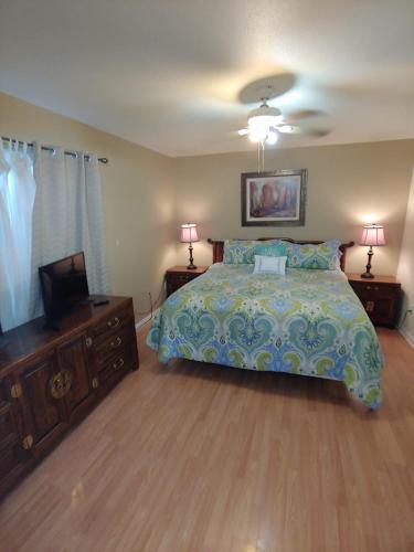 a bedroom with a bed and a flat screen tv at Make Your Friends Jealous! in Indio