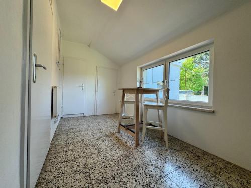 an empty room with a table and a window at atrium roselina in Kirchstetten