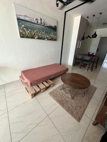 a living room with a bed and a table at Blest Loft 12 Manhattan Suites ITCC in Penampang