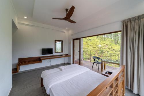 ein Schlafzimmer mit einem Bett und einem Balkon in der Unterkunft WINTEL WILD in Vālpārai