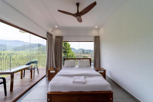 a bedroom with two beds and a large window at WINTEL WILD in Vālpārai