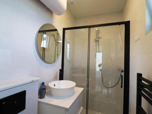 a bathroom with a sink and a shower at Cottage in Menaam near Frisian Landscape in Menaldum