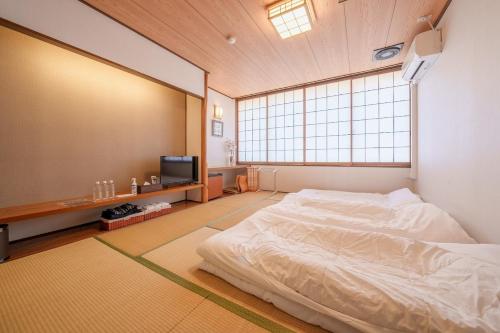 a bedroom with a bed and a large window at Fuji Yamanakako Resort Hotel - Vacation STAY 03076v in Yamanakako