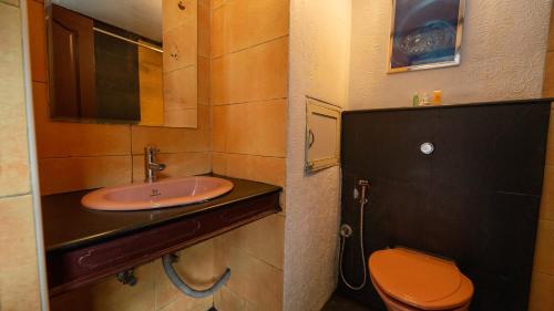 a bathroom with a sink and a toilet at Westwood Riverside in Munnar