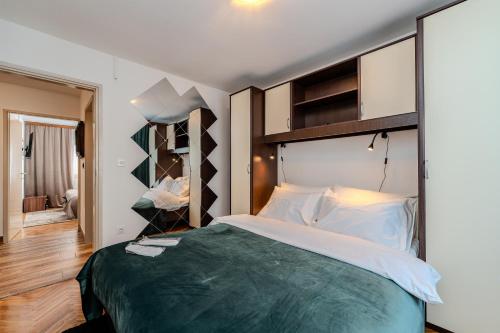 a bedroom with a large bed with a large headboard at Villa I&M in Jasenice