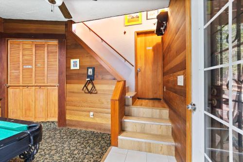 a room with a staircase with a pool table at HotTub PingPong Arcade Billiard Pets AC Piano BBQ Art in Twain Harte