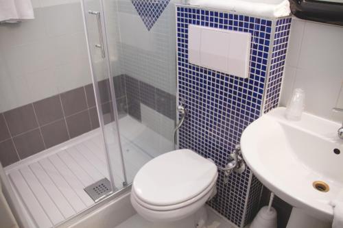 a bathroom with a toilet and a sink and a shower at Hotel Letizia in Orte