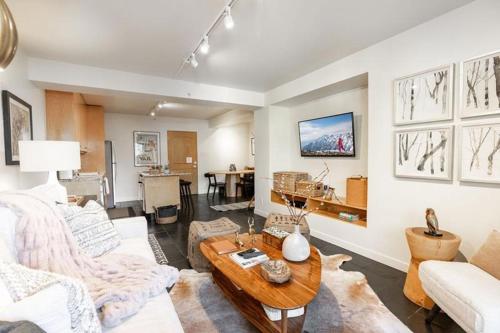 a living room with a couch and a table at Condo with Onsite Pool & Hot Tub, Free WiFi & Garage Parking in Vail