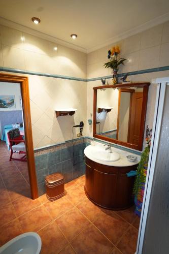 a bathroom with a sink and a mirror at Casa El Sol in Mota del Cuervo