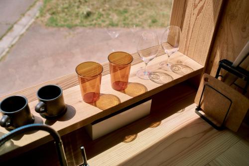 a group of glasses and wine glasses on a window sill at ist-Sado in Sado