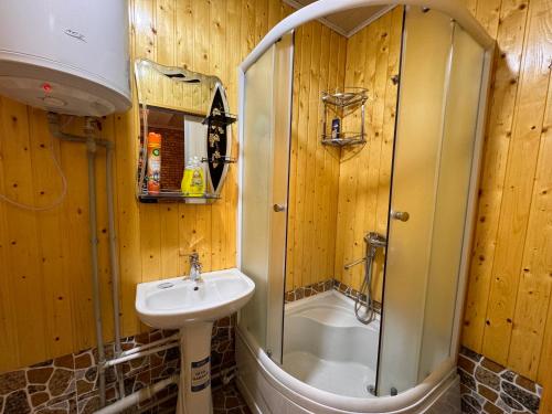 a bathroom with a shower and a sink at Panjrud guest house in Panjakent