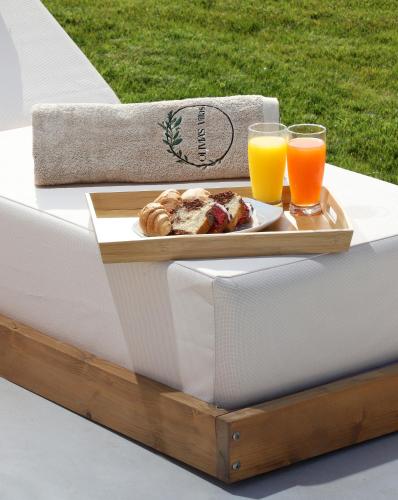 a tray of food and two glasses of orange juice at OLIVIA'S Villas in Mochlos