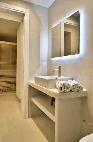 a bathroom with a sink and a mirror at OLIVIA'S Villas in Mochlos