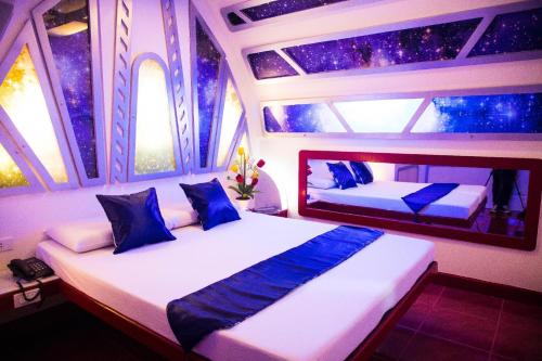 a bedroom with two beds on a yacht at Astrotel Avenida in Manila