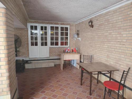 a room with a table and a table and chairs at Suzangaran House in Samarkand