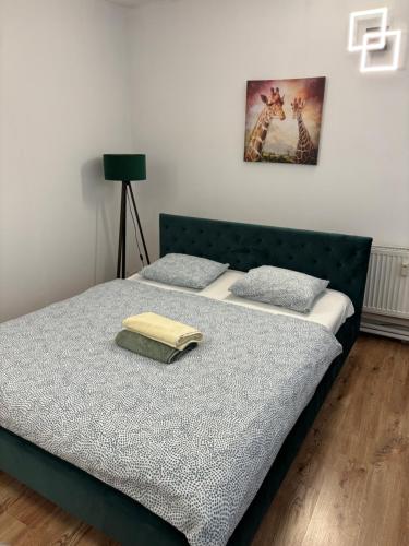 a bed with two pillows on it in a room at Central Apartment NEW STUDIO in Košice