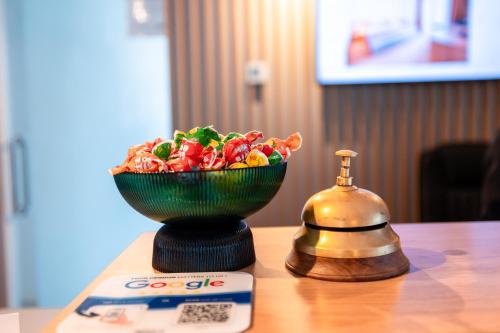 a bowl of candy on a table next to a scale at Stil Hotel in Bucharest