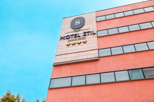a building with a clock on the side of it at Stil Hotel in Bucharest
