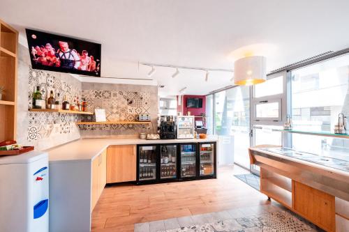 a kitchen with a counter with alcohol bottles at Stil Hotel in Bucharest