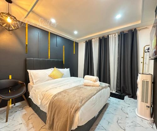a bedroom with a bed and a desk and a television at Golden Suites Baguio in Baguio