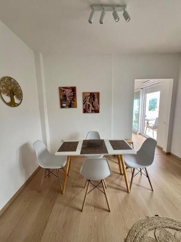 a dining room with a table and four chairs at MINA modern & cozy apartment main city square GTC Skopje in Skopje