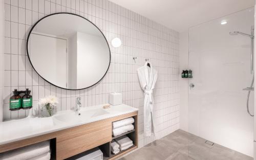 a bathroom with a sink and a mirror at Crowne Plaza Adelaide by IHG in Adelaide