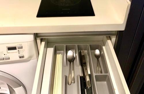 a drawer in a kitchen with utensils in it at Circle S Sukhumvit12 NearBTS,MRT in Bang Kapi