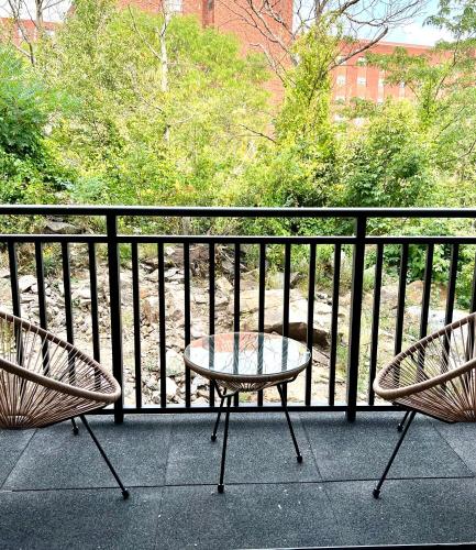 two chairs and a table on a balcony at Luxury 2 Bed Apartment in Quincy in Quincy