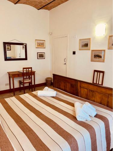 Postel nebo postele na pokoji v ubytování Fattoria Podere i Luoghi