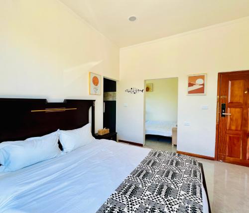 a bedroom with a bed with a black and white bedspread at coral coast FIJI in Sigatoka