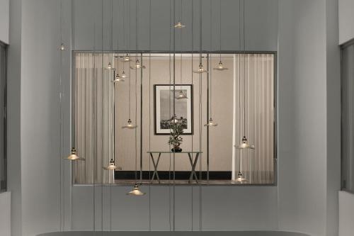 a glass window with a table with a plant in it at Sanasaryan Han, a Luxury Collection Hotel, Istanbul in Istanbul