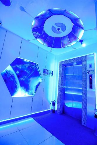 a bathroom with a shower with a blue light at Astrotel Novaliches in Manila
