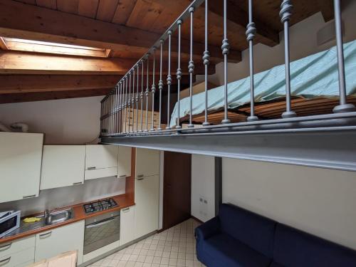 a staircase in a kitchen with a blue couch at a casa di Leo in Capriate San Gervasio