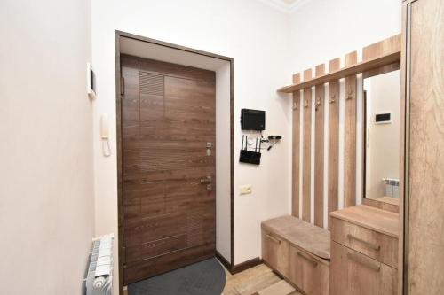 a bathroom with a wooden door and a staircase at Luxe Apartment in the Center of Yerevan 007 in Yerevan