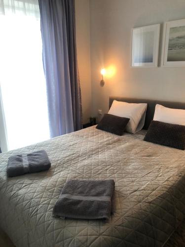 a bedroom with a bed with two towels on it at Cosy 1 bedroom apartment in the heart of old town with parking in Kaunas